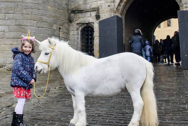 Visitor Amy Miller with Princess the unicorn at  the gates of Stirling Castle.  Picture - Helen Pugh.