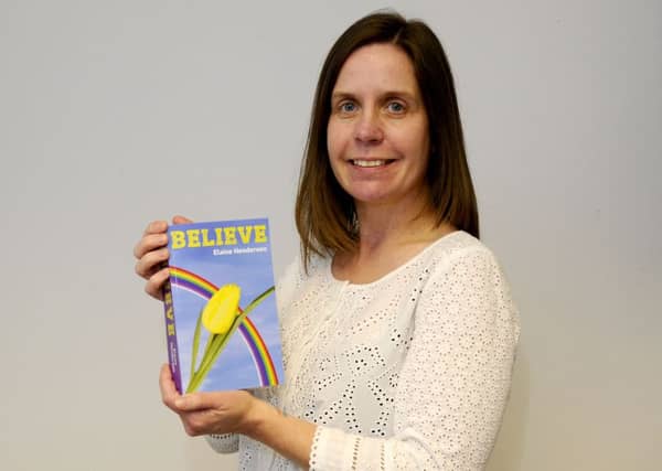 Elaine Henderson with her book