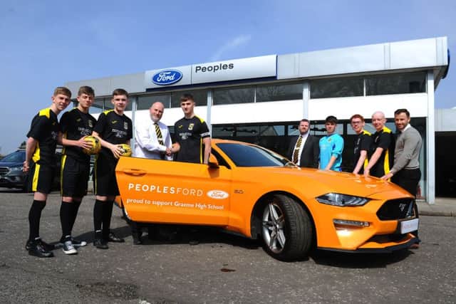 18-04-2019. Picture Michael Gillen. SFFH_190271  MG  12.30pm. FALKIRK. Grahams Road. Peoples Ford Falkirk. Graeme High School footballers preview pics ahead of Scottish Schools Shield Final. Peoples Ford Falkirk are the shirt sponsors. George Renwick, sales manager (white shirt); Jamie Scott, captain; Ian feron, general sales manger (suit) and Zander Murray, coach (far right).