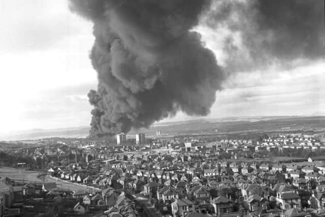 Flames and smoke billowing across the rooftops from the fire at the Scottish Tar Distllers' plant at Camelon near Falkirk in November 1973.