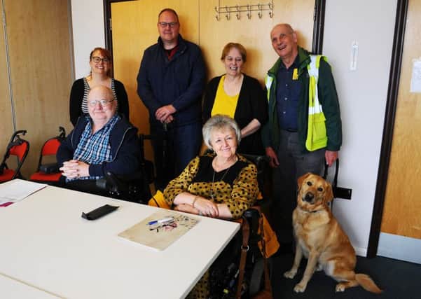 Working together...to secure better access for disabled people are (front) chairman George Williamson and vice-chairman Jennie McCartney and (back) secretary Karen Procek, Alex Smith, Diane Williamson and treasurer Michael Anderson with his guide dog Quin. (Pic: Michael Gillen)