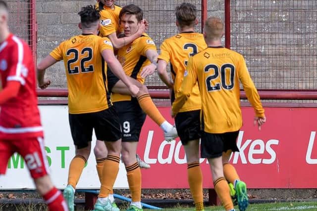 Mark McGuigan (Stenhousemuir) celebrates with team mates after scoring during the Scottish League 1 match between Brechin City and Stenhousemuir at Glebe Park, where a draw was enough to see Brechin City relegated to League 2.

(c) Dave Johnston