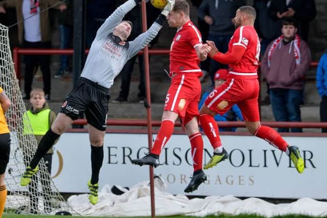 Stenhousemuir goalkeeper Graeme Smith saves from Dougie Hill (Brechin City) and Callum Tapping (Brechin City) during the Scottish League 1 match between Brechin City and Stenhousemuir at Glebe Park, where a draw was enough to see Brechin City relegated to League 2.

(c) Dave Johnston