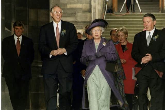 The First Minister of Scotland Donald Dewar, the Queen and Presiding Officer Sir David Steel make their way out of the General Assembly building to greet the crowds during the celebrations to mark the opening of the Scottish Parliament on July 1, 1999.