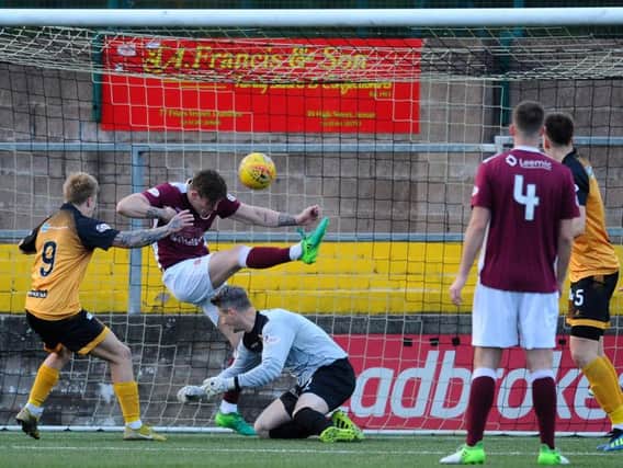 Mark McGuigan can't prevent the second Annan goal