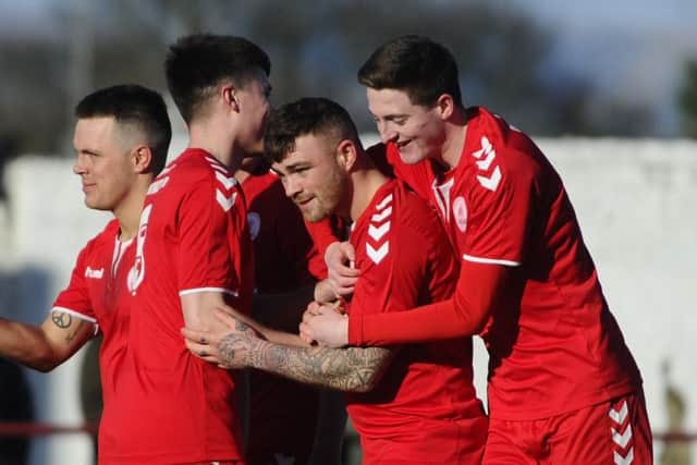 Anderson is swamped by his team-mates after yet another goal. Picture: Alan Murray