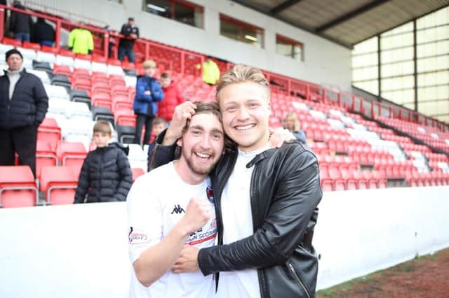 Ray Grant is congratulated by brother Peter after Clyde's promotion win. Picture Craig Black