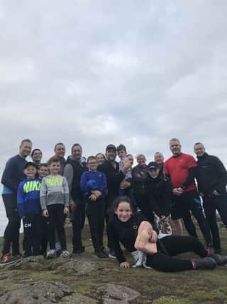 Gordon MacNicol and his friends and family at the top of Dumyat. Gordon is raising money for SANDS by climbing Dumyat each day after a colleague lost her baby seven days before her due date.