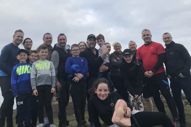 Gordon MacNicol and his friends and family at the top of Dumyat