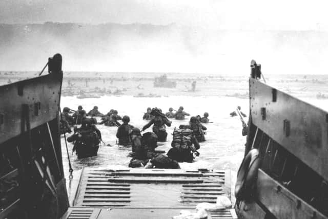 Soldiers disembarking from landing craft - of the sort driven by Leading Seaman Don Argent.