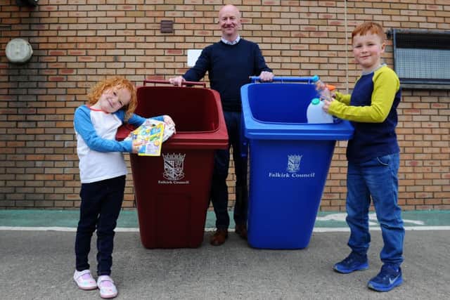Councillor Paul Garner with Lois Friel and Leo Friel and the new bins.