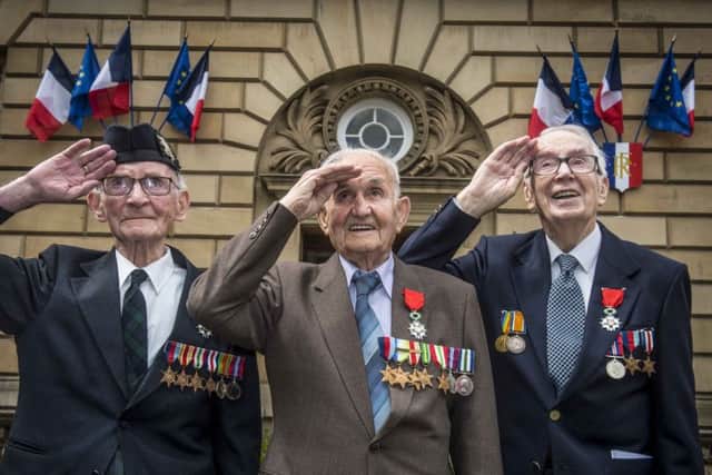 Jack Adamson,left, takes the salute outside the French Consulate in Edinburgh with fellow D Day veterans David Livingston and Robert Jobson Paton.