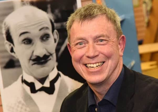 Alistair Young, pictured beside a portrait of his illustrious cousin.
