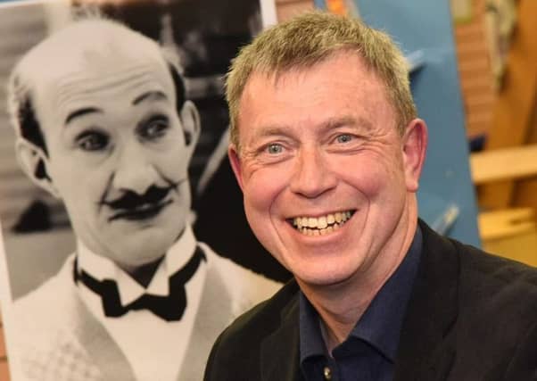 Alistair Young, pictured beside a portrait of his illustrious cousin.