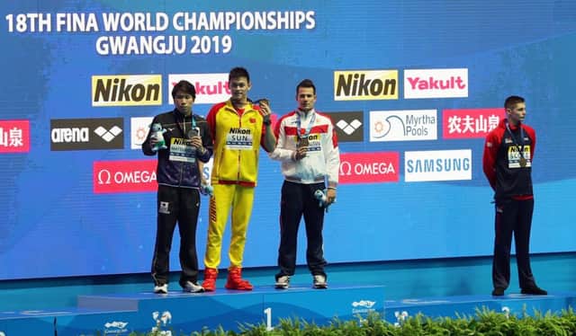 GWANGJU, SOUTH KOREA - JULY 23: (L-R) Silver medalist Katsuhiro Matsumoto of Japan, gold medalist Sun Yang of China and bronze medalists Martin Malyutin of Russia and Duncan Scott of Great Britain pose during the medal ceremony for the Men's 200m Freestyle Final on day three of the Gwangju 2019 FINA World Championships at Nambu International Aquatics Centre on July 23, 2019 in Gwangju, South Korea. (Photo by Catherine Ivill/Getty Images)