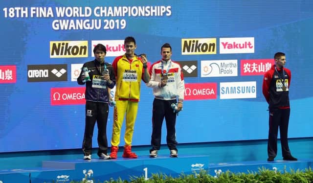 GWANGJU, SOUTH KOREA - JULY 23:  (L-R) Silver medalist Katsuhiro Matsumoto of Japan, gold medalist Sun Yang of China and bronze medalists Martin Malyutin of Russia and Duncan Scott of Great Britain pose during the medal ceremony for the Men's 200m Freestyle Final on day three of the Gwangju 2019 FINA World Championships at Nambu International Aquatics Centre on July 23, 2019 in Gwangju, South Korea. (Photo by Catherine Ivill/Getty Images)