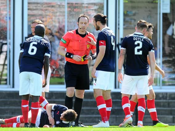 Gregor Buchanan discusses a cynical foul on team-mate Charlie Telfer with ref Barry Cook