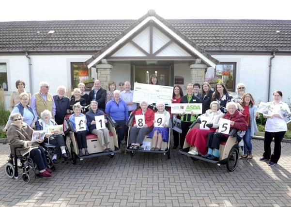 A happy day at Airthrey Care Home last year, when Asda Stenhousemuir general manager Neil Millar passed on a cheque for nearly £19,000 to buy trishaw bikes for use by the residents.