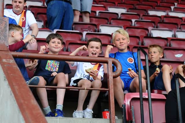 A section of young Stenny fans cheer the Warriors on to the pitch.
