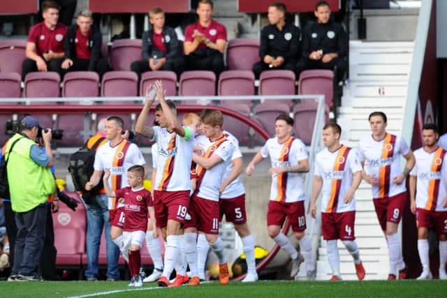 Stenny captain Andy Munro leads his team out on to the Tynecastle pitch.
