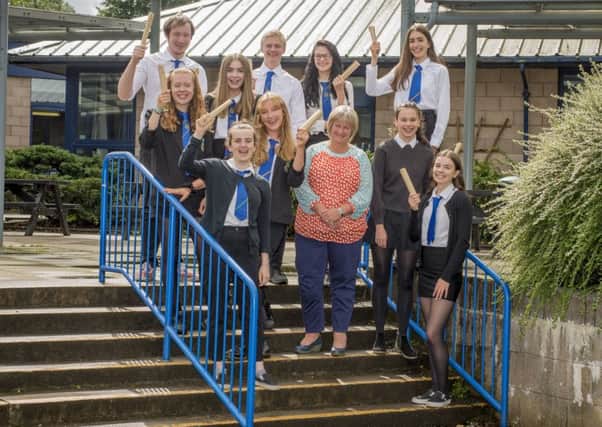 Pupils from Linlithgow Academy celebrate their exam success with Headteacher Karen Jarvis. Photo by Ian R Fleming.