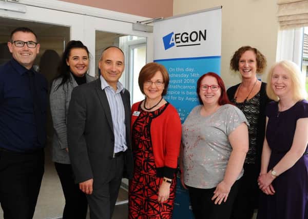 Staff from Aegon with in the centre their charities chairperson John Moos and Marjory Mackay, Director of Nursing Strathcarron Hospice.