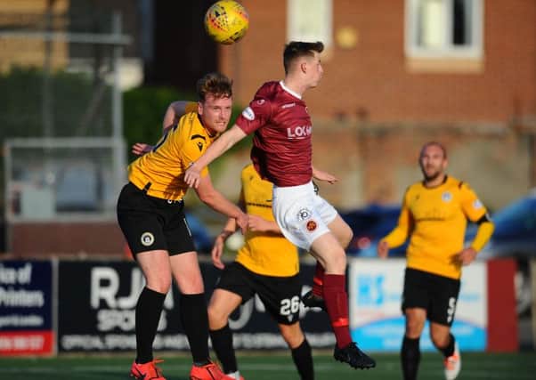 Stenhousemuir in action as Ryan Watters challenges for the ball