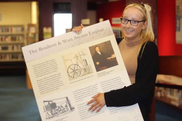 Fern Christie helps set up one of the Watt displays at the Boness Library exhibition. (Pic: Adrian Mahoney)
