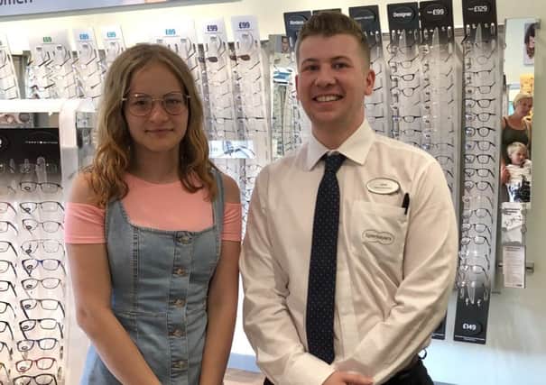 Marina Shukharenka of Belarus received a free eye examination during her visit to Specsavers Linlithgow at the Regent Centre in Blackness Road and was given two complimentary pairs of glasses. She is pictured with Calum, one of the stores optical assistants.