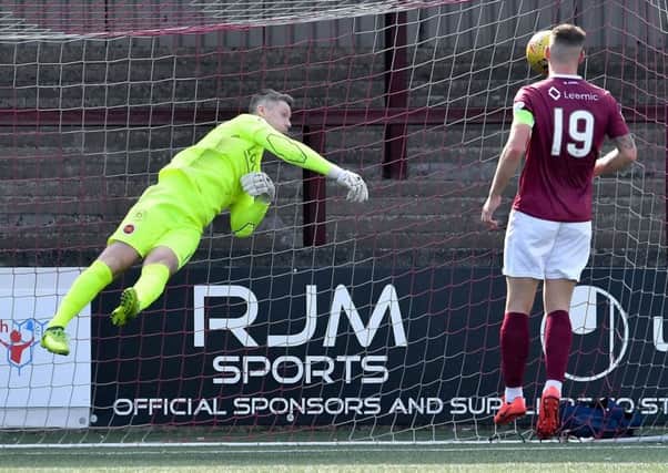 Stenhousemuir goalkeeper Graeme Smith pushes a shot wide .
picture:  Dave Johnston