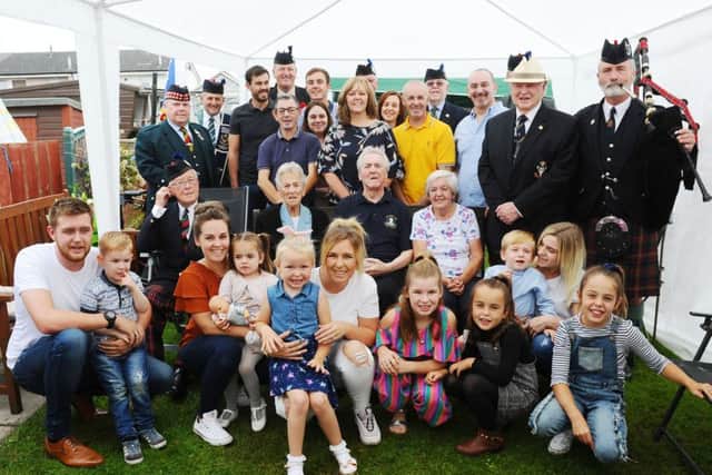 Family members and military personnel ensured Bobby Allan, pictured centre, had a birthday to remember
