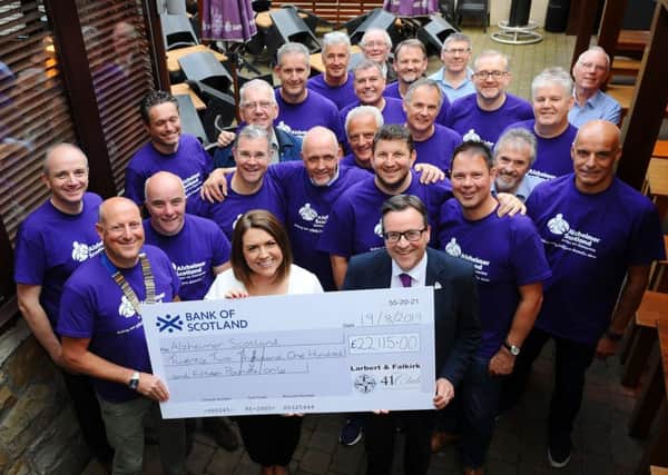 Team of Larbert and Falkirk 41 Club Dragon's Spine cyclists presenting a cheque for £22,115 to representatives of Alzheimer Scotland after their cycle in Wales.  Pic: Michael Gillen.