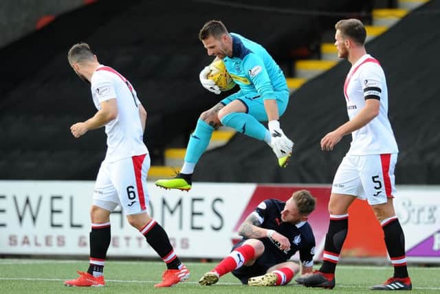 Aerial antics against Falkirk by Airdrieonians 'keeper David Hutton (picture by Michael Gillen).