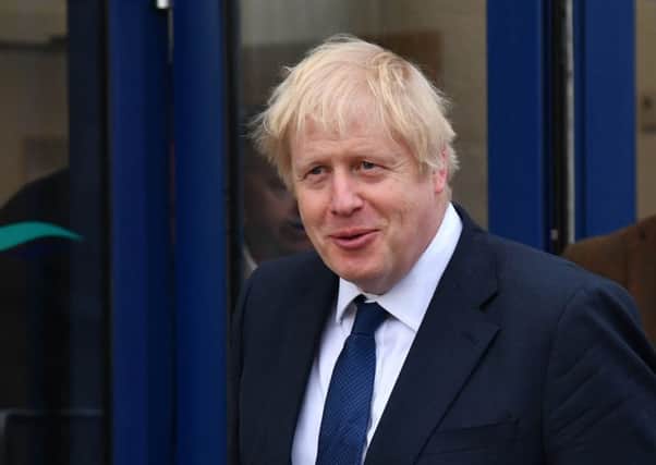 Prime Minister Boris Johnson pictured leaving Peterhead fish market during yesterday's visit to Scotland.