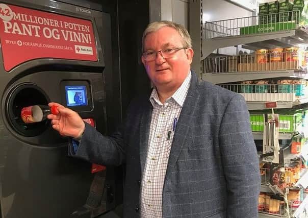 Falkirk East MSP Angus MacDonald uses a deposit return device during a trip to Norway