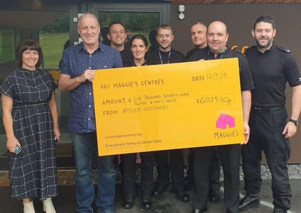 Cammy, (holding cheque, left) with Maggie's staff and police officers who took part in the successful Three Peaks Challenge fundraiser