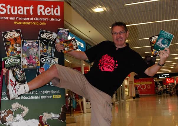 Stuart Reid in classic form, promoting a Let's Read event at the Howgate.