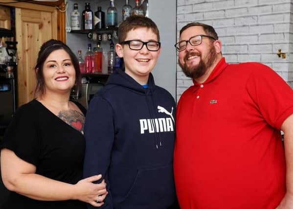 Karen and George Robertson are pictured with son Blair who was diagnosed with transverse myelitis. Picture: Michael Gillen