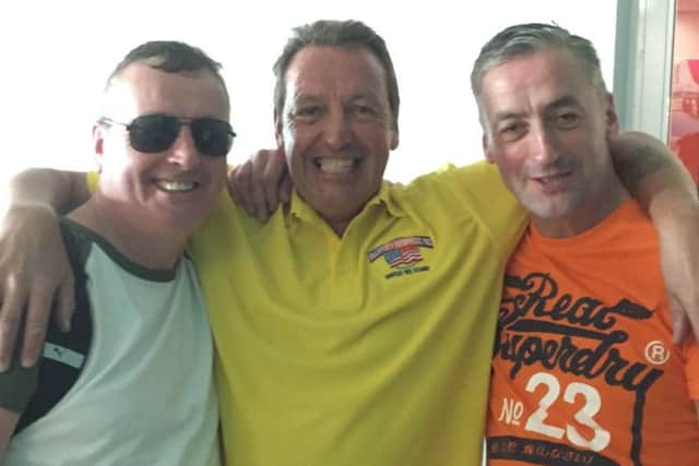 Martin, centre, pictured in more relaxed times - before Hurricane Dorian vented its fury