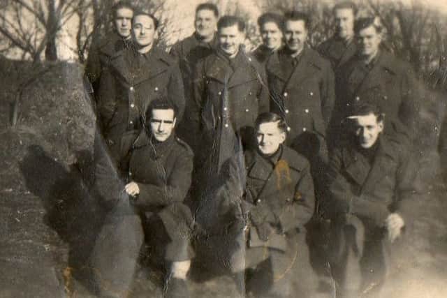 Ian's dad is smallest of the men in the back row.