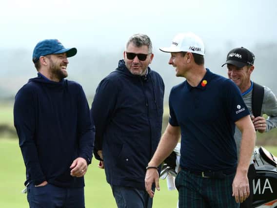 Justin Rose of England stands with musician, Justin Timberlake as they share a joke on the fifth green during previews for the Alfred Dunhill Links Championship. (Photo by Mark Runnacles Getty Images)