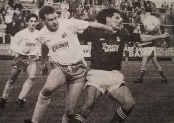 Falkirk attacker Simon Stainrod tussles for the ball with ex-Bairn Ian McLeod - Falkirk 7-1 Raith Rovers
