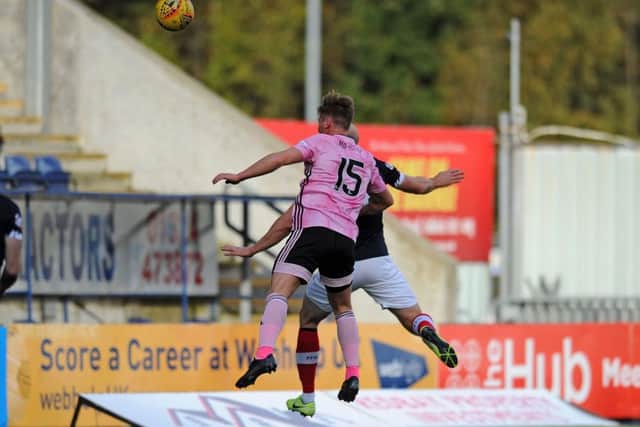 Conor Sammon loops a header over Greg Fleming