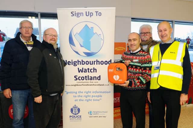 Pictured: Raymond Murray, business owner Card Rack; Jim Muir, Denny and District Community Council; Jock McLaughan, Co-op store manager; Brian McCabe, Denny and District Community Council; and Bill Gray, Denny Neighbourhood Watch and Denny and District Community Council. Picture: Michael Gillen