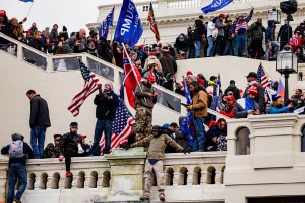 Thousands of Trump supporters gathered outside the Capitol building, scaling the walls and breaching barricades (Photo: Samuel Corum/Getty Images)